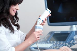 Female doctor squeezing special gel from tube to procedure.